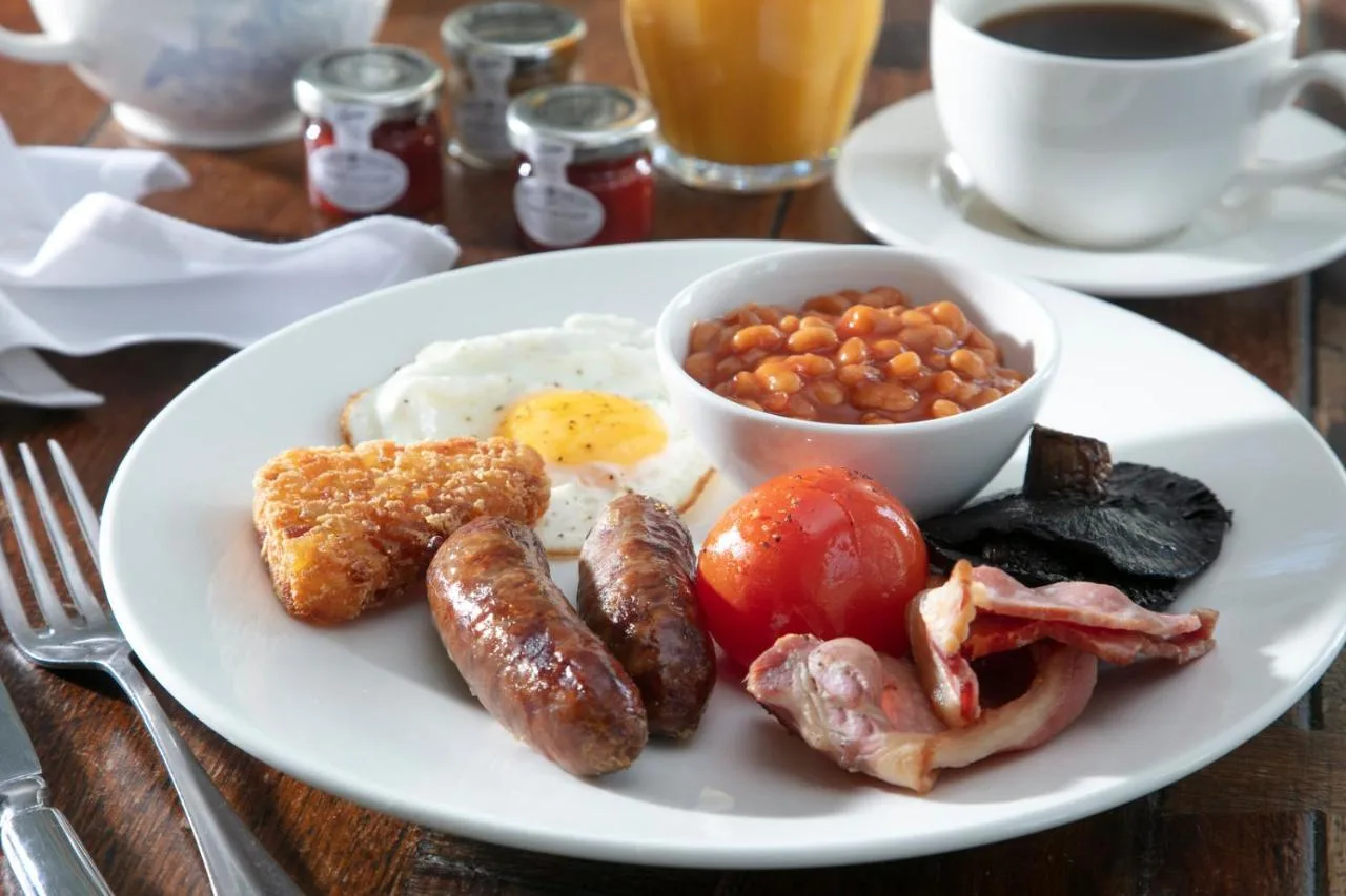 A plate of breakfast food with eggs, sausage, beans and tomatoes at Lansdown Grove Hotel in Bath
